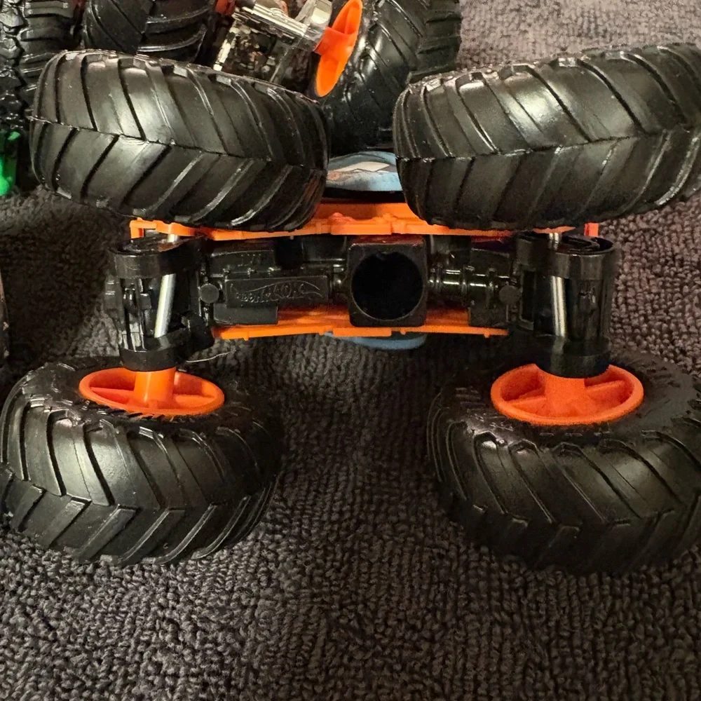 Hot Wheels 4 lot of Monster Truck Toys. Assorted Colors (Green, Orange, Blue)